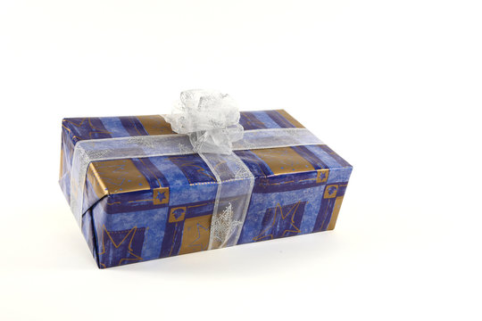 Christmas present in blue paper with silver tie