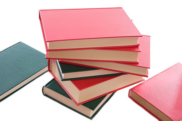 Many books red and green  stacked on a white background