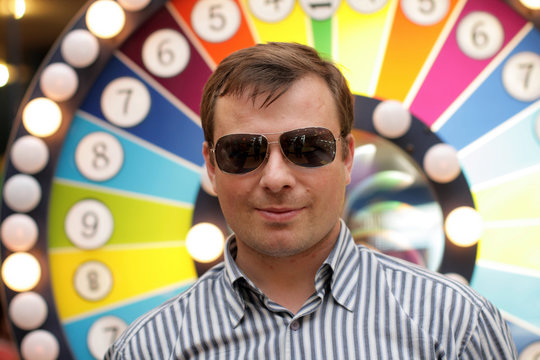 The man in glasses poses in a casino
