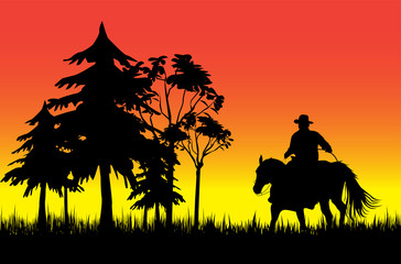 Cowboy on a horse over sunset