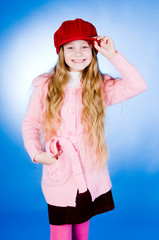 Little girl in red cap, studio shot