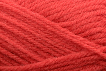 Close-up shot of red yarn, perfect for backgrounds or textures.