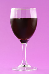 glass of red wine, pink background