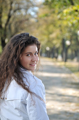 Fototapeta premium Happy young woman smiling outdoors in park