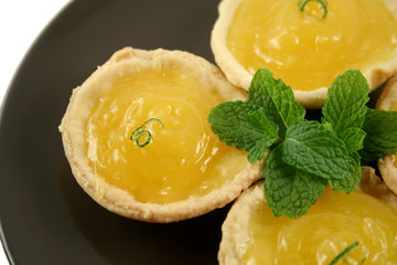 Delightful lemon tarts with a lime twist and mint.