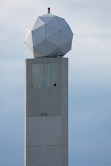 Doppler radar tower ball over blue sky with clipping path