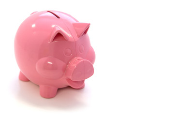 Happy pink plastic piggy bank over white background