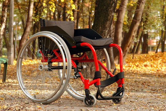 Empty active wheelchair in the park in fall time
