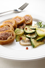 Stuffed fried pancakes with meat and vegetable salad
