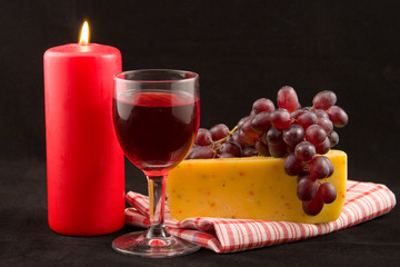 wine and candle on a black background