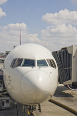 Nose of a commercial jetliner at the boarding gate