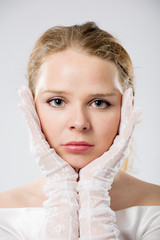 grey-eyed woman in white gloves close-up portrait