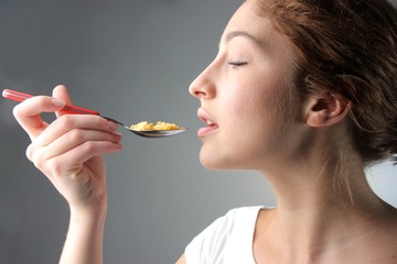 beautiful woman eating cornflakes