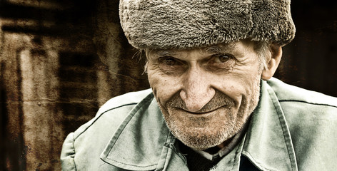 Vintage grungy portrait of smiling old man