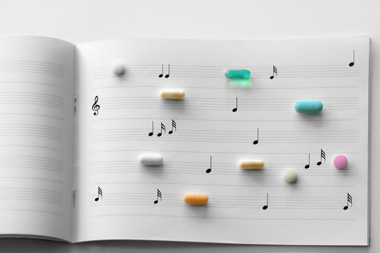 Prescription pills on white lined music note paper
