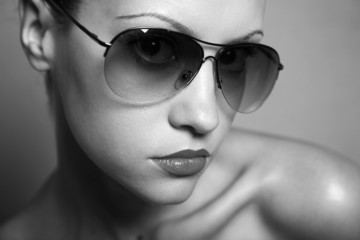 Fashion portrait of young pretty woman with glasses