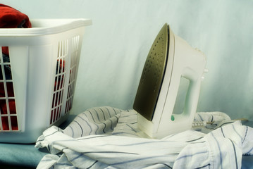 Clean laundry about to be ironed on an ironing board