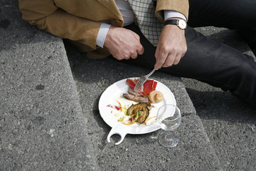 Italian business man eating his lunch outdoors in his break.