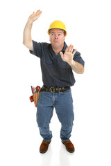 Construction worker trapped in imaginary box.