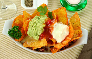 Delicious vegetarian nachos with guacamole and salsa