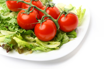 salad and cherry tomatoes isolated on white background