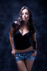 Fototapeta na wymiar attractive young woman, studio dark background