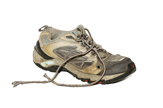 Old dirty running shoe isolated over white
