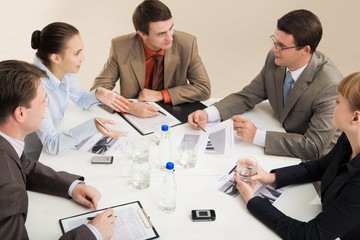 Portrait of business people sitting around table