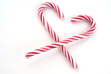 Candy canes isolated on a white background in a heart shape