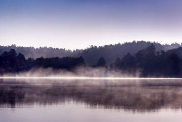 Fototapeta na wymiar Mist over lake at dawn. Mazury, Poland. aRGB.