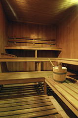 Fototapeta na wymiar Empty wooden sauna with a bucket of water