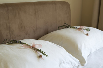 Beautiful bedroom interior with white sheets and flowers