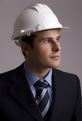 Portrait of young businessman - isolated in grey background