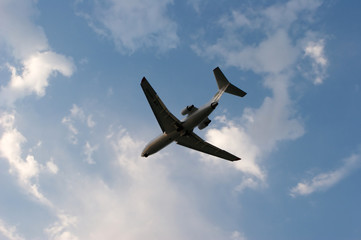 Silhouette of airplane in blue sky