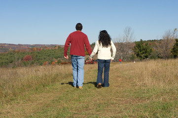 Couple walking outdoors in autumn