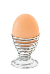 Boiled egg isolated on white in chrome egg cup