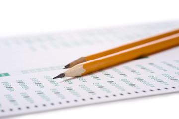 A yellow pencil on a computer read examination or test