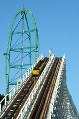 Two roller coasters against blue sky