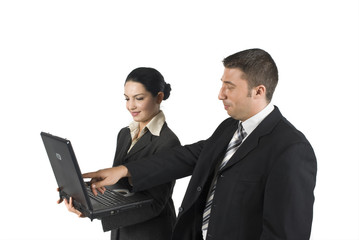 Obraz premium Two business people show something on laptop and laugh about...