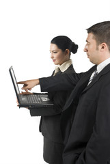 Businessman showing something on laptop to his associate
