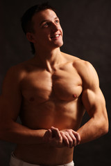 Fototapeta premium young sensual man on a black background