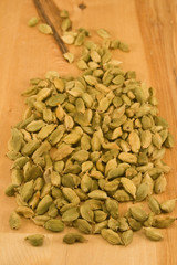 Cardamom fruits on wood