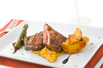 Gourmet dish with meat, asparagus and pears, studio shot.