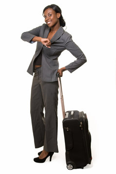 Business woman with luggage checking time