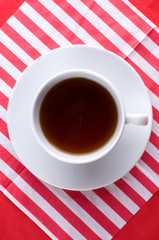 Cup with tea on  wooden table.