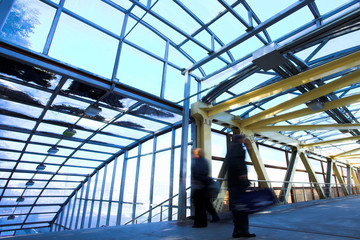 Yellow metal corridor with windows, crowd mooving