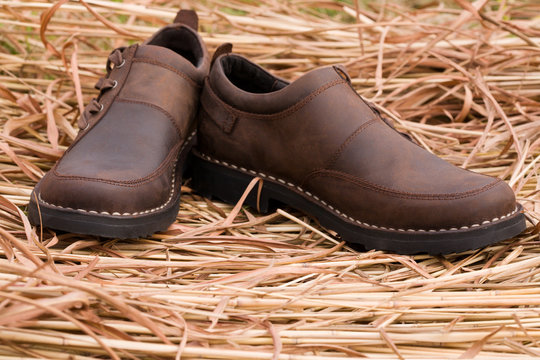 New man's boots from a leather on a background of a dry grass.