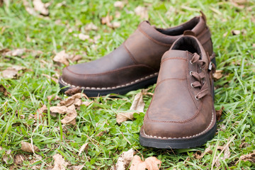 New man's boots from a leather on a background of a grass.Fall.