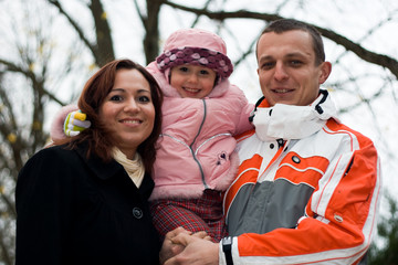 Smiling young family in park