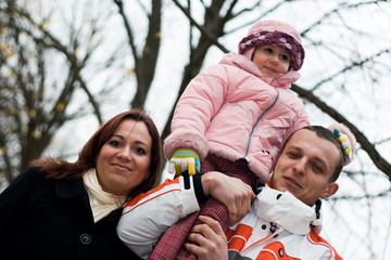 Young parents with child in autumn park